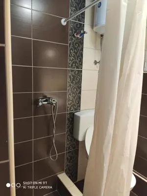 a bathroom with a shower with a toilet and a sink at Excellency apartmani in Banja Luka