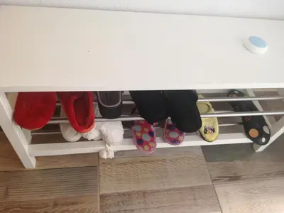 a white drawer with shoes and other shoes on it at Excellency apartmani in Banja Luka