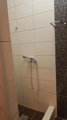 a shower with a hose in a bathroom at Excellency apartmani in Banja Luka
