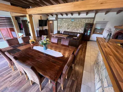 a large wooden table and chairs in a living room at Villa Sarajevo in Vareš