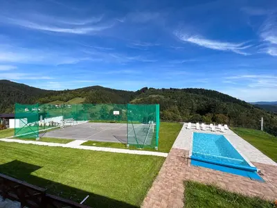 an image of a tennis court with chairs and a tennis racket at Villa Sarajevo in Vareš