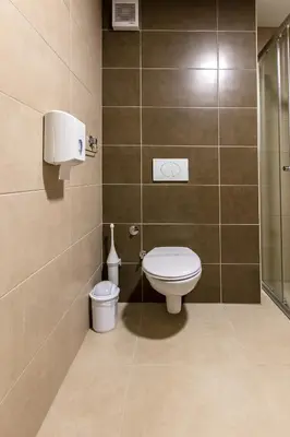 a bathroom with a toilet and a shower at Hotel IUT in Travnik