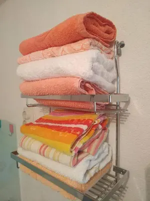 a pile of towels on a rack in a closet at Apartman Ana in Livno