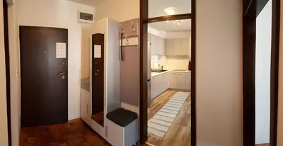 a room with a mirror and a hallway with a kitchen at Apartment Emina in Travnik