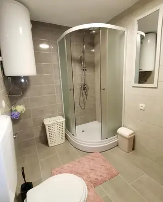 a bathroom with a shower and a toilet and a sink at Kuća Vila Nina in Tomislavgrad