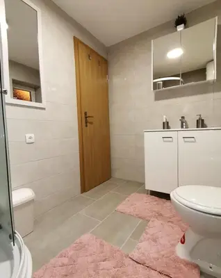 a bathroom with a toilet and a sink at Kuća Vila Nina in Tomislavgrad