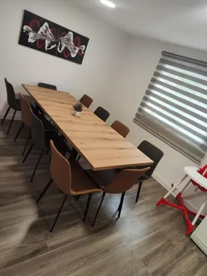 a dining room with a wooden table and chairs at Kuća Vila Nina in Tomislavgrad