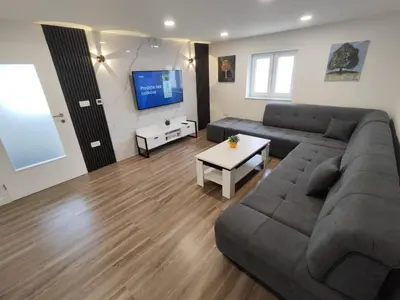a living room with a couch and a tv at Kuća Vila Nina in Tomislavgrad