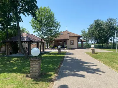 a house with a pavilion and a walkway at Vikendica Atos in Nova Topola