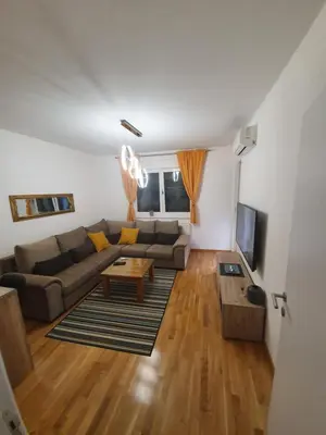 a living room with a couch and a table at Apartman Lux Doboj in Doboj