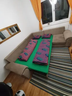 a living room with a couch with pillows on it at Apartman Lux Doboj in Doboj