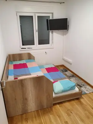 a bed in a room with a window at Apartman Lux Doboj in Doboj