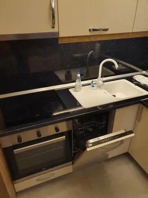 a kitchen counter with a sink and a sink at Apartman Lux Doboj in Doboj