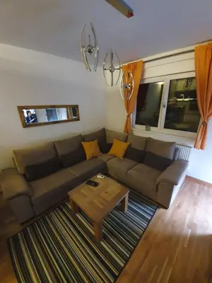 a living room with a couch and a coffee table at Apartman Lux Doboj in Doboj