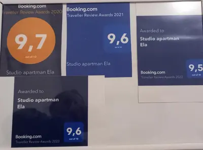 a group of signs hanging on a wall at Studio apartman Ela in Travnik
