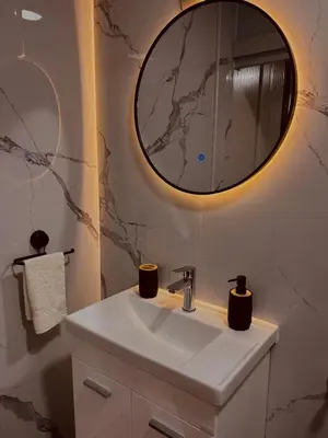 a bathroom with a sink and a mirror at Apartman Deluxe Una Holiday in Bihać