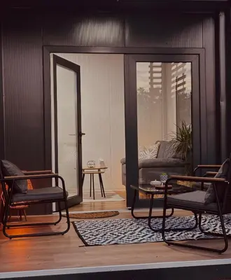 a living room with two chairs and a couch at Apartman Deluxe Una Holiday in Bihać
