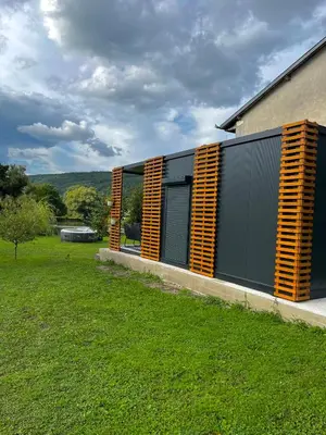 a building with yellow shutters on the side of it at Apartman Deluxe Una Holiday in Bihać