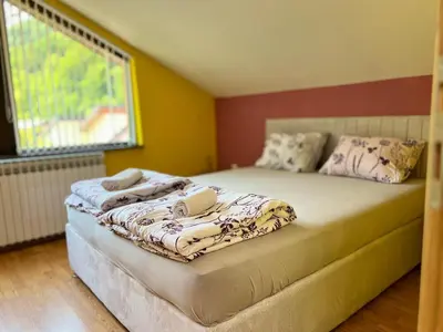 a bedroom with two beds with pillows and a window at Villa Sun Visoko in Visoko
