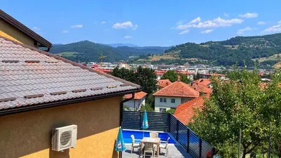 a balcony of a house with a table and chairs at Villa Sun Visoko in Visoko