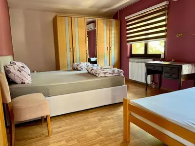 a bedroom with two beds and a desk and a window at Villa Sun Visoko in Visoko