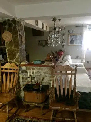 a bedroom with a table and two chairs and a bed at Spacious and Charming House in Vozuća with Large Garden in Vozuća