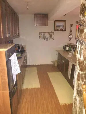 a kitchen with wooden floors and a counter top at Spacious and Charming House in Vozuća with Large Garden in Vozuća