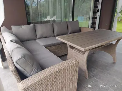 a couch and a table on a patio at House Legacy in Bihać