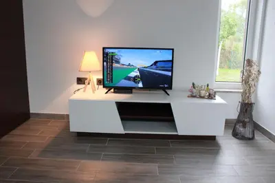 a white entertainment center with a flat screen tv on it at House Legacy in Bihać