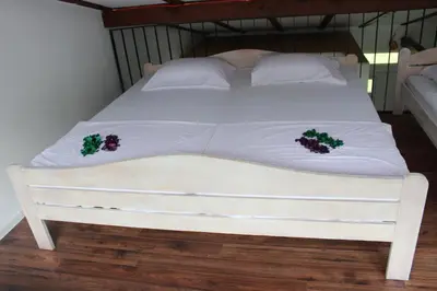 a white bed with white pillows and christmas decorations at House Legacy in Bihać