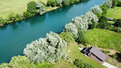 an aerial view of a house next to a river at House Legacy in Bihać