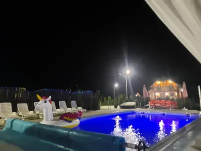 a swimming pool at night with a ride in the middle at Live Nature in Bihać