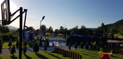 a playground with a pool and trees in a field at Live Nature in Bihać