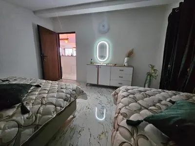 a bedroom with a bed and a dresser and a mirror at Villa Adanis in Bihać