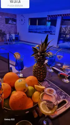 a plate of fruit on a table with a pineapple at Villa Adanis in Bihać