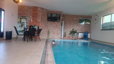 a small child swimming in a swimming pool at Villa Adanis in Bihać