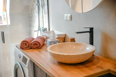 a bathroom with a large bowl sink on a counter at Apartments Centar in Živinice