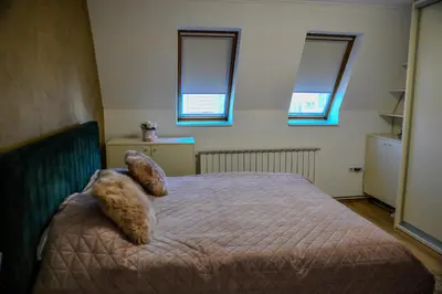a bedroom with a bed with two pillows on it at Apartments Centar in Živinice