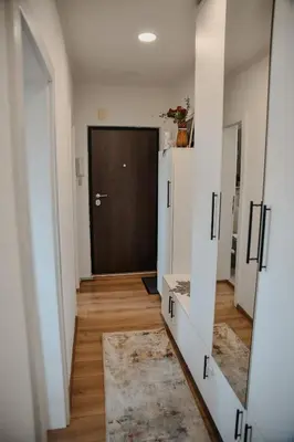 a hallway with a large mirror and a door at Apartments Centar in Živinice