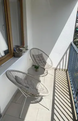two chairs and a table on a balcony at Apartments Centar in Živinice