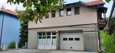 a house is being constructed with a garage at Apartman Željo in Livno
