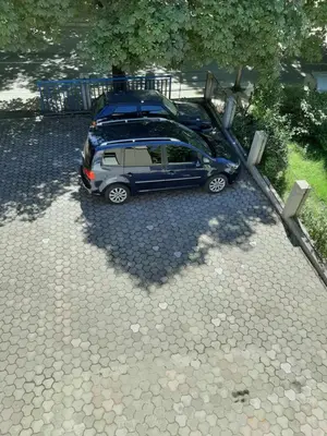 two cars are parked in a parking lot at Apartman Željo in Livno