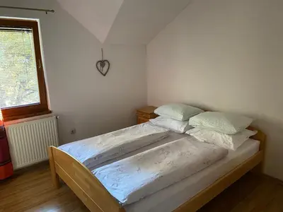 a large bed in a bedroom with a window at Apartman Željo in Livno