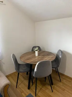 a table and chairs in a room with a table at Apartman Željo in Livno