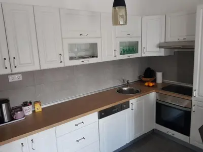 a kitchen with white cabinets and a sink at Apartman DIJANA in Banja Luka