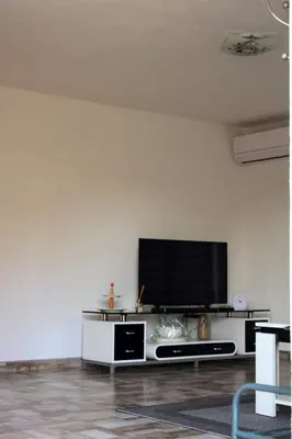 a living room with a flat screen tv on a wall at 