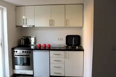 a kitchen with white cabinets and a stove at 
