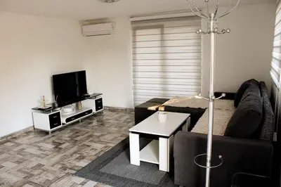 a living room with a black couch and a tv at 