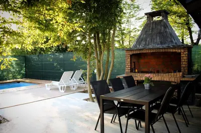 a patio with a table and chairs and a fireplace at 