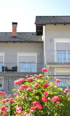 a bunch of red flowers in front of a building at Villa Jajce in Jajce